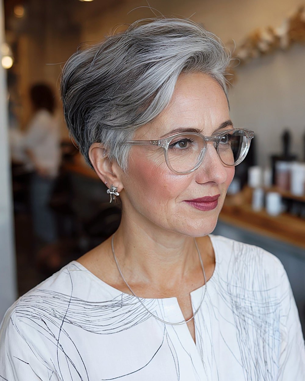 Short grey pixie cut with volume on top and tapered back for women over 60